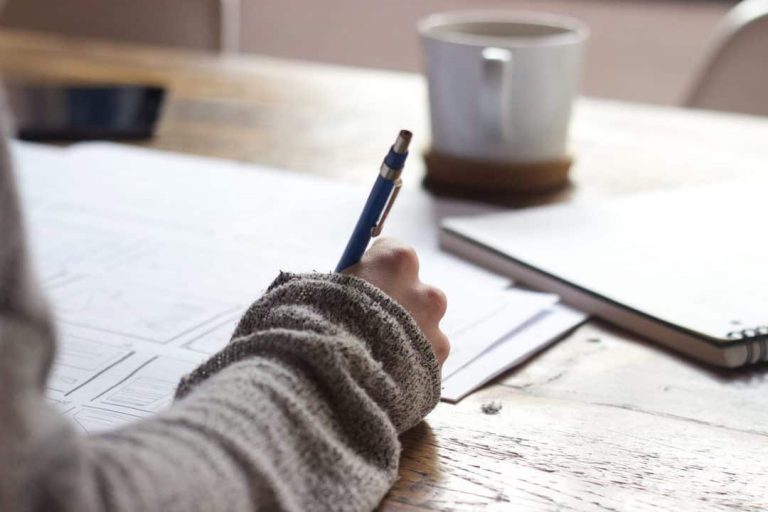 Resume writing, A women writing something in a paper