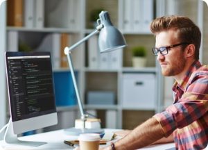Developerlooking at the code in the monitor
